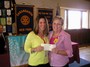 The Club recently donated $500 plus a four-year pledge of $2000 each year to be used for special equipment and special events. Pictured are Heather Pawlak receiving the Rotary Club check from Rhoda Childs.